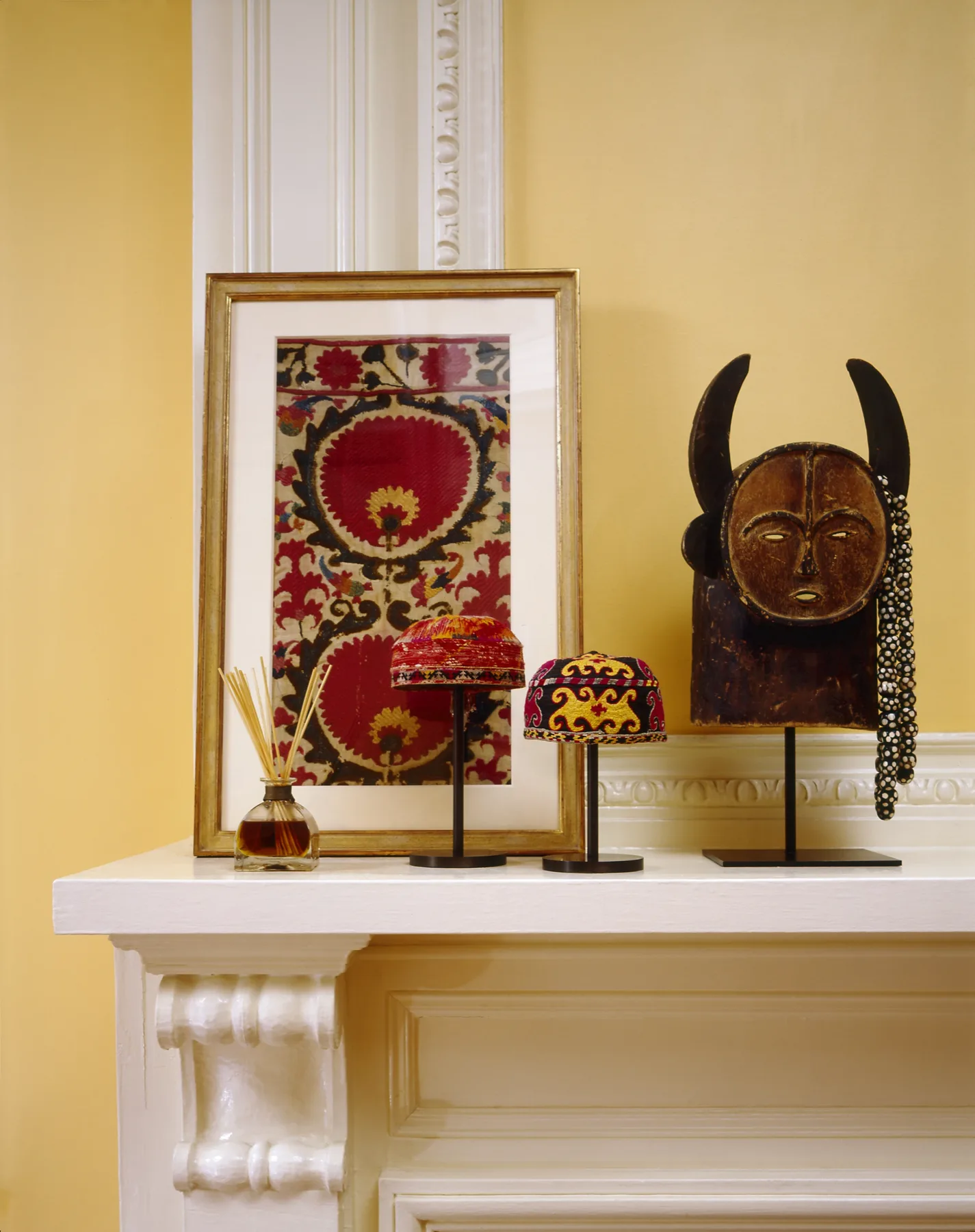 Intimate dining alcove with patterned kilim and golden candlelight in a Manhattan apartment