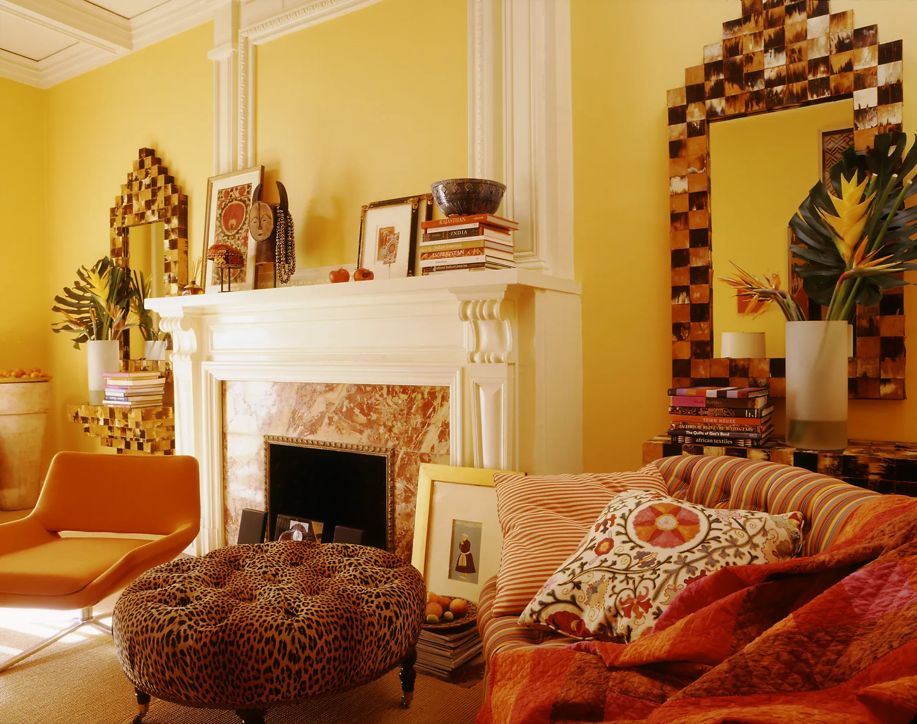 Detail of collected antiques and jewel-toned upholstery in a New York interior
