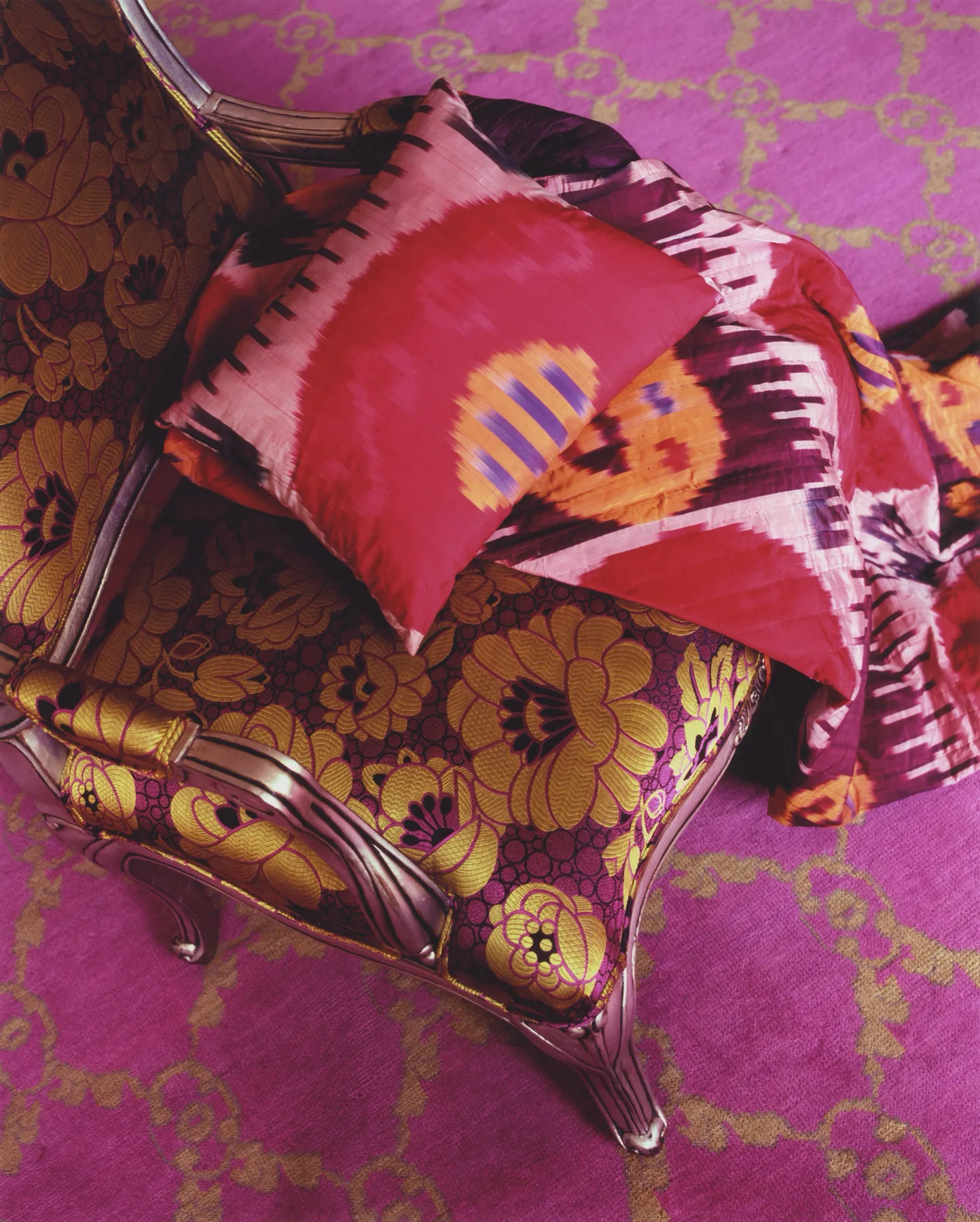 Detail of peony-pink upholstery and absinthe-green walls in a Parisian interior