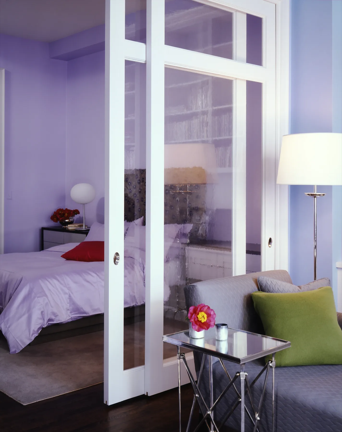 Intimate sitting area with bold violet palette and European antique pieces