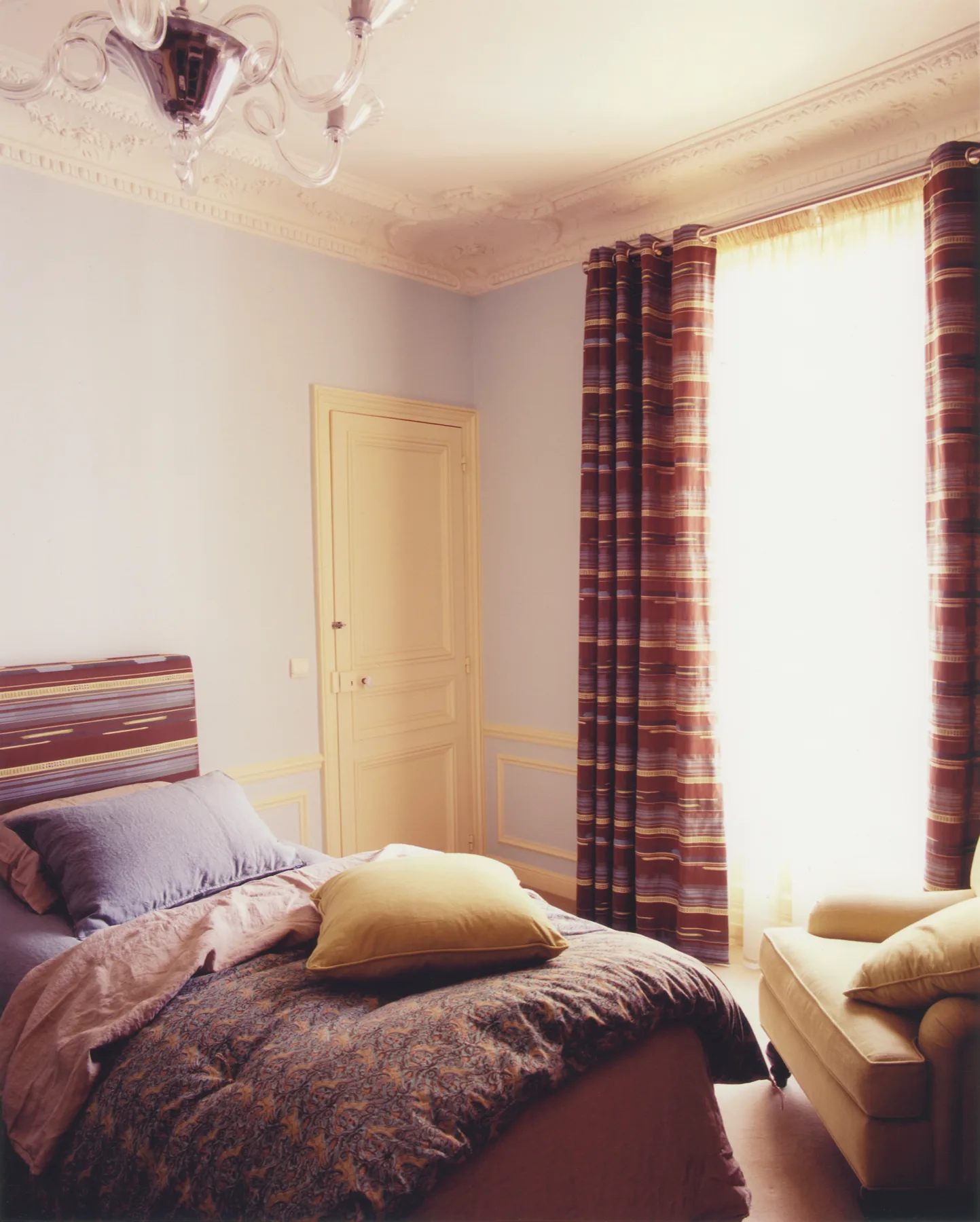 Intimate corner with richly colored textiles and collected vintage objects