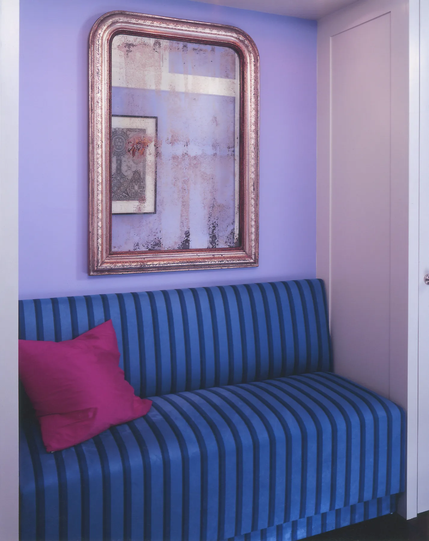 Detail of richly patterned upholstery and collected objects in a New York apartment
