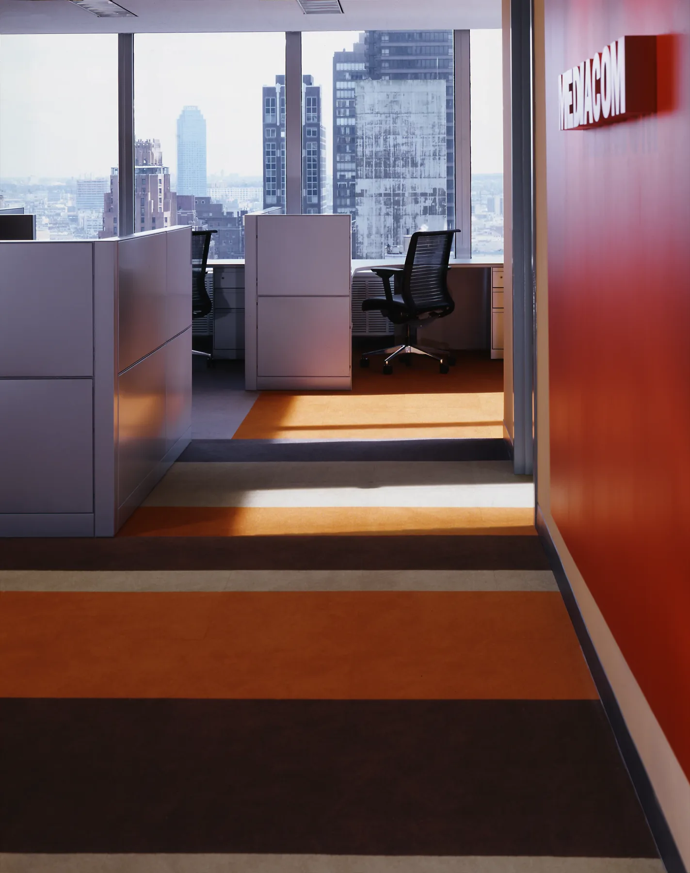 Corporate reception with architectural restraint and burnt-orange accent wall, Grey Global Headquarters New York