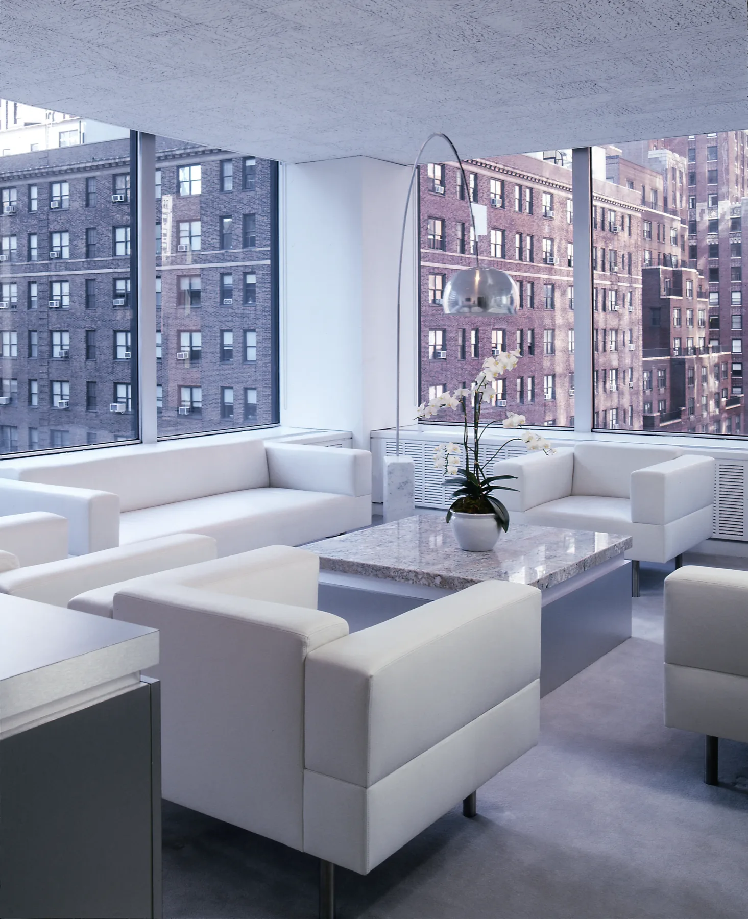 Corporate corridor with deep orange accent and warm grey materiality, Manhattan